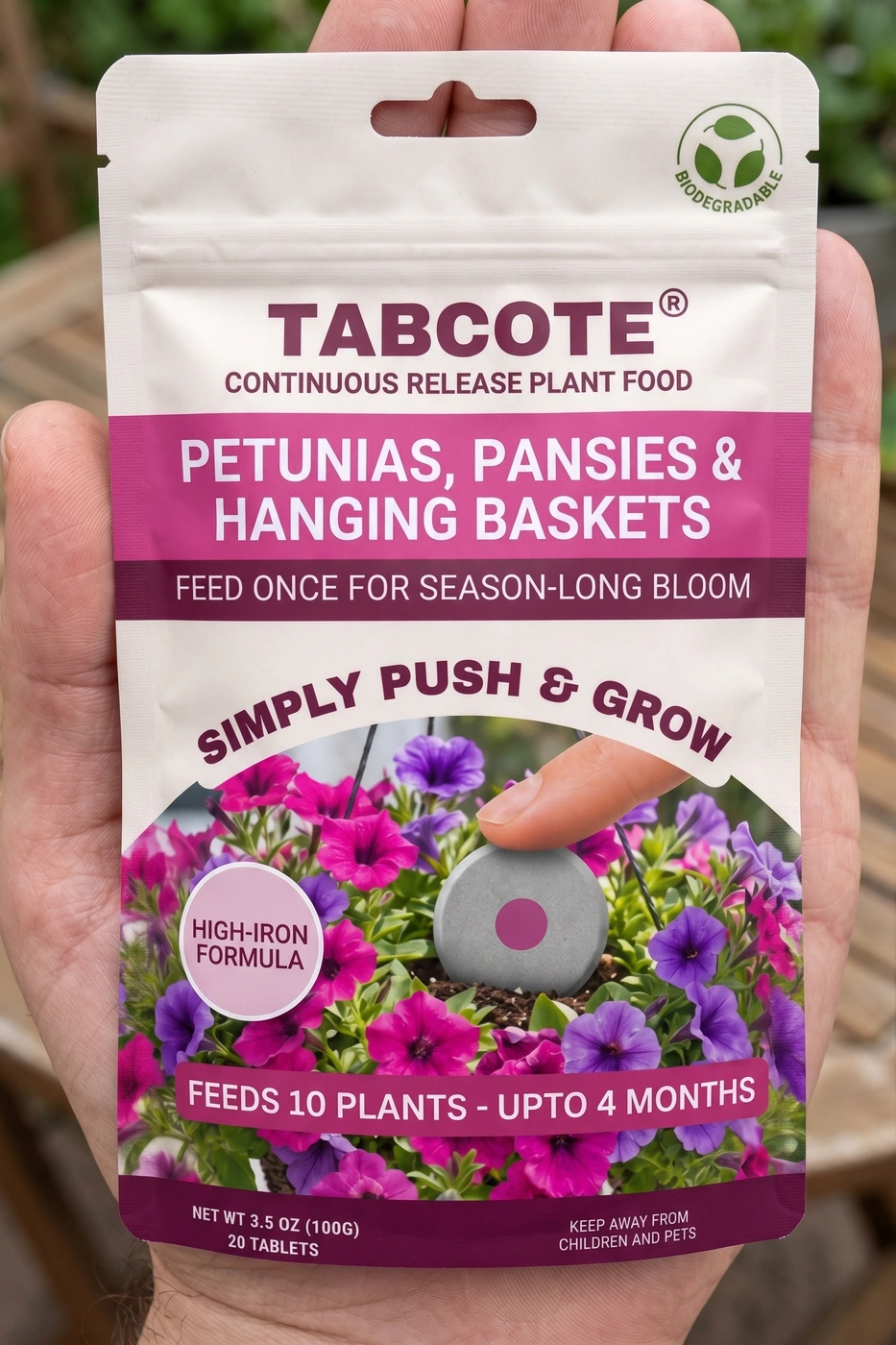 A compact TABCOTE petunia pouch held in the palm of a hand